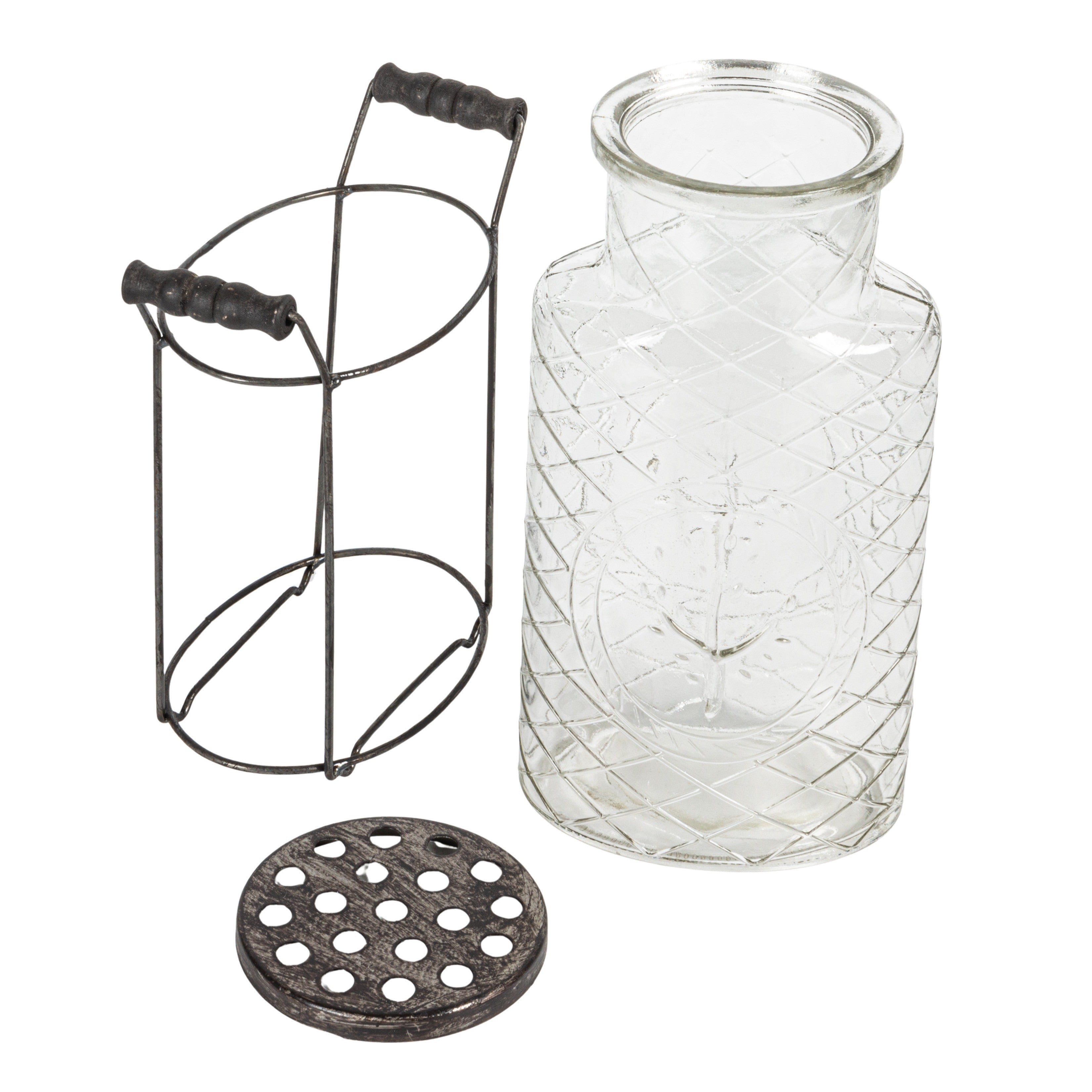 A clear glass vase with a metal stand and frog lid